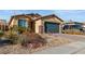 Attractive single-story house featuring desert landscaping, rock features, and a spacious driveway at 2128 Delmar Farms Ct, Laughlin, NV 89029