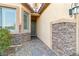 Inviting front entrance with stone accents, desert landscaping, and a covered entryway at 2128 Delmar Farms Ct, Laughlin, NV 89029