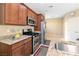Kitchen features granite counters, stainless steel appliances, and wood cabinets at 2128 Delmar Farms Ct, Laughlin, NV 89029