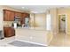 Open kitchen featuring granite counters, wood cabinets, tile flooring, and modern appliances at 2128 Delmar Farms Ct, Laughlin, NV 89029
