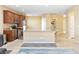 Open kitchen featuring granite counters, wood cabinets, tile flooring, and modern appliances at 2128 Delmar Farms Ct, Laughlin, NV 89029