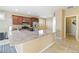 Open kitchen featuring granite counters, wood cabinets, tile flooring, and modern appliances at 2128 Delmar Farms Ct, Laughlin, NV 89029