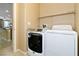 Functional laundry room featuring a modern washer and dryer, and shelf at 2128 Delmar Farms Ct, Laughlin, NV 89029