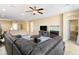 Bright living area with neutral walls, open floorplan, ceiling fan, and tile flooring at 2128 Delmar Farms Ct, Laughlin, NV 89029