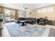 Spacious living room with tile floors, a ceiling fan, neutral paint, and sliding glass doors at 2128 Delmar Farms Ct, Laughlin, NV 89029