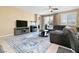Spacious living room with tile floors, a ceiling fan, neutral paint, and sliding glass doors at 2128 Delmar Farms Ct, Laughlin, NV 89029