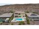 An aerial view of a luxurious backyard with a pool, spa, outdoor kitchen, and manicured landscaping at 2153 King Crest Ct, Henderson, NV 89052