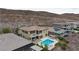 A luxury home displays its pool, patio, pergola, and landscaping, complemented by a scenic mountain backdrop at 2153 King Crest Ct, Henderson, NV 89052