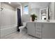 Elegant bathroom featuring a tub with shower, gray vanity with double sinks, and a large mirror for added convenience at 2153 King Crest Ct, Henderson, NV 89052