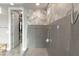 Glass enclosed shower displays neutral tiling, a shower bench, and storage cubbies at 2153 King Crest Ct, Henderson, NV 89052