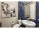 Stylish powder room with blue herringbone wall design and modern artwork at 2153 King Crest Ct, Henderson, NV 89052