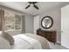 Comfortable bedroom with a dark dresser and natural light from the window at 2153 King Crest Ct, Henderson, NV 89052