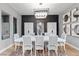 Stunning dining room with modern chandelier, designer decor, and seating for eight at 2153 King Crest Ct, Henderson, NV 89052