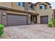 A modern home features a spacious three-car garage and a beautifully paved driveway at 2153 King Crest Ct, Henderson, NV 89052