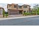 Stunning two-story home with a well-manicured lawn, mature landscaping, a two-car garage, and neutral color palette at 2153 King Crest Ct, Henderson, NV 89052