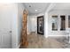 Elegant hallway featuring light gray walls, unique driftwood art, and wood-look tile flooring at 2153 King Crest Ct, Henderson, NV 89052