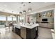 Open concept kitchen with island seating and dining area, featuring an outdoor view and modern design at 2153 King Crest Ct, Henderson, NV 89052