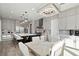 Elegant eat-in kitchen features stainless appliances, an island with seating, and modern chandelier lighting at 2153 King Crest Ct, Henderson, NV 89052