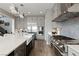 Bright kitchen with stainless appliances, a large island with a sink, and decorative backsplash at 2153 King Crest Ct, Henderson, NV 89052