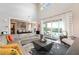 Bright living room featuring a high ceiling and opening to a pool area through sliding glass doors at 2153 King Crest Ct, Henderson, NV 89052