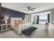 Spacious bedroom with a decorative accent wall and sitting area bathed in natural light at 2153 King Crest Ct, Henderson, NV 89052