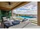 Inviting covered patio with comfortable seating area overlooking a pristine pool, hot tub, and city views at 2153 King Crest Ct, Henderson, NV 89052