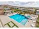 Outdoor living offers a modern pool with a spa, tanning ledge, built-in grill, and desert landscaping at 2153 King Crest Ct, Henderson, NV 89052