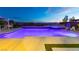 Modern pool at dusk features in-ground spa, and water feature at 2153 King Crest Ct, Henderson, NV 89052