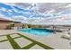 Beautiful backyard pool and spa with a stylish patio area, outdoor kitchen, and lush landscaping at 2153 King Crest Ct, Henderson, NV 89052