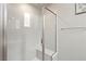 Glass enclosed shower featuring a built-in bench and modern tile at 2153 King Crest Ct, Henderson, NV 89052