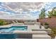 Relaxing spa and lounge area with a fire pit, landscaping, and plenty of space for outdoor seating at 2153 King Crest Ct, Henderson, NV 89052