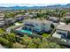 Aerial view of a backyard featuring a sparkling pool, patio area, and lush landscaping, great for outdoor living at 220 Villa Borghese St, Las Vegas, NV 89138