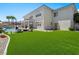 Expansive backyard with lush lawn, covered patio, and inviting pool area at 220 Villa Borghese St, Las Vegas, NV 89138