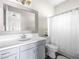 Cozy bathroom with gray cabinets, a large framed mirror, and white shower curtain at 220 Villa Borghese St, Las Vegas, NV 89138