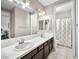 Bright bathroom featuring a double vanity with white countertops and dark brown cabinets at 220 Villa Borghese St, Las Vegas, NV 89138