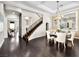Elegant dining area with dark hardwood floors, decorative chandelier, and staircase access at 220 Villa Borghese St, Las Vegas, NV 89138