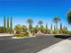 Community entrance sign with palm trees and well-maintained landscaping at 220 Villa Borghese St, Las Vegas, NV 89138