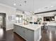 Open kitchen concept with marble island, stainless appliances, seamlessly flowing into a dining and living area at 220 Villa Borghese St, Las Vegas, NV 89138