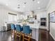Spacious kitchen featuring an island with bar stools, white cabinets, and stainless steel appliances at 220 Villa Borghese St, Las Vegas, NV 89138