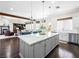 Open-concept kitchen with granite countertops, stainless steel appliances, and a view of the living area at 220 Villa Borghese St, Las Vegas, NV 89138