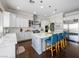 Gourmet kitchen with a large island, white cabinets, stainless steel appliances, and dark wood floors at 220 Villa Borghese St, Las Vegas, NV 89138