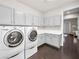 Bright laundry room with gray cabinets, white countertops, and stainless steel appliances at 220 Villa Borghese St, Las Vegas, NV 89138