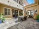 Outdoor patio with travertine pavers, dining set, string lights, and a tranquil ambiance at 220 Villa Borghese St, Las Vegas, NV 89138
