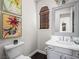 Quaint powder room with a framed mirror and a dark wood accent wall at 220 Villa Borghese St, Las Vegas, NV 89138