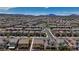 Aerial view showcasing a meticulously designed community with uniformly styled homes, and a lush green common area at 242 Polaris Ridge Ave, Henderson, NV 89011