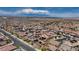 Expansive aerial view of a meticulously planned community, showcasing the neighborhood's layout and nearby mountain views at 242 Polaris Ridge Ave, Henderson, NV 89011