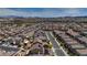 An aerial view of a neighborhood showcasing a network of homes set against a backdrop of rolling hills at 242 Polaris Ridge Ave, Henderson, NV 89011