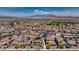 Wide-angle aerial view of a neighborhood with homes, solar panels, and mountain backdrop at 242 Polaris Ridge Ave, Henderson, NV 89011