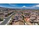 Scenic aerial view showcases the rooftops of a suburban neighborhood, mountains in distance at 242 Polaris Ridge Ave, Henderson, NV 89011