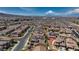 An aerial view displays the well-organized neighborhood layout with neat rows of houses beneath a bright blue sky at 242 Polaris Ridge Ave, Henderson, NV 89011